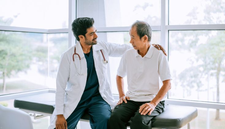 A male doctor talking to a male patient.