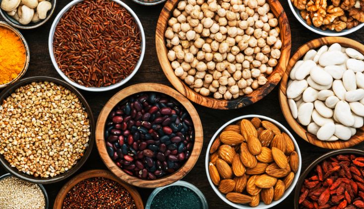 Small wooden bowls holding different nuts and seeds