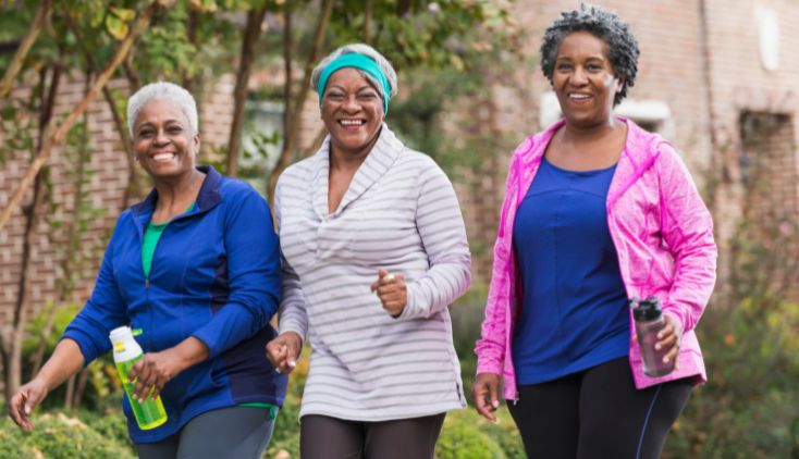 Three women walking together outside.