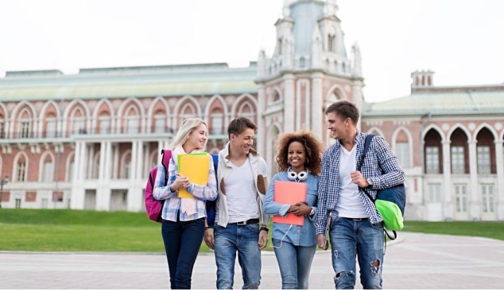 A group of students standing together outside of an old building.