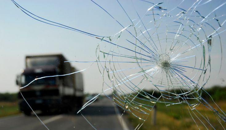 A windshield with a very large crack in it.