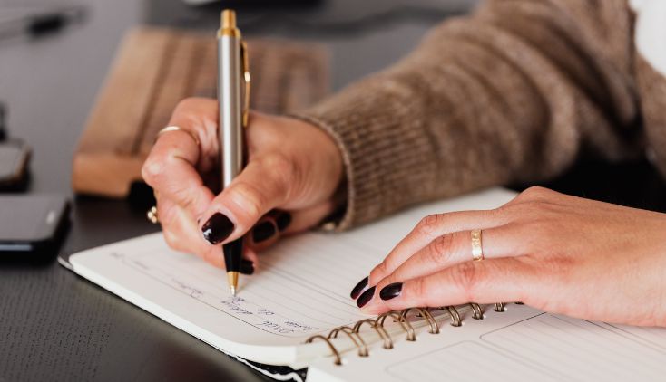 A woman taking notes in a notebook